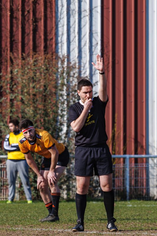 Rugby referee blowing whistle during CS Clichy match in Clichy, March 2025