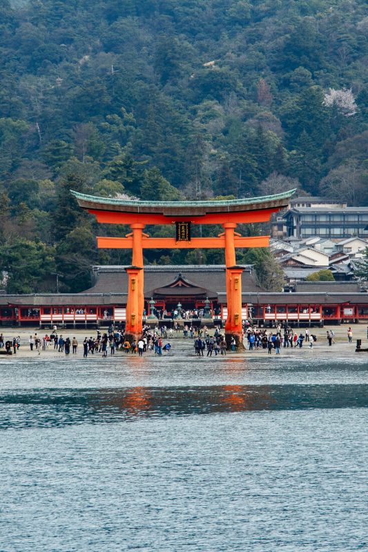 Itsukushima Shrine floating torii gate at low tide with visitors on Miyajima Island